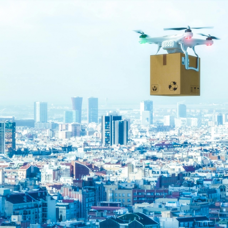 drone carrying package over large city
